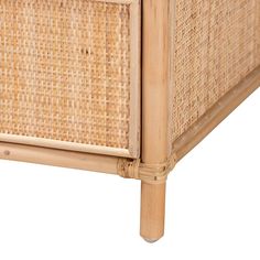 an image of a wicker bed frame with wood legs and headboard on white background