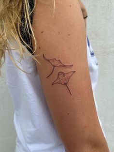 a woman's arm with a tattoo on it that has an image of a bird