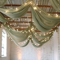 a room filled with lots of lights and drapes hanging from the ceiling above it