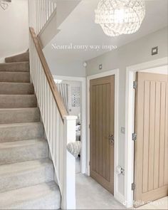 an entry way with stairs and chandelier