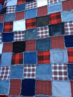 an old patchwork quilt with blue, red and black patches on the bottom half