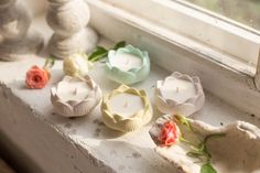 some candles are sitting on a window sill