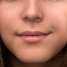 a woman with a nose piercing on her nose