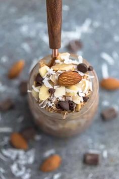 a dessert in a glass with nuts and chocolate