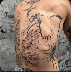 the back of a man with tattoos on his chest