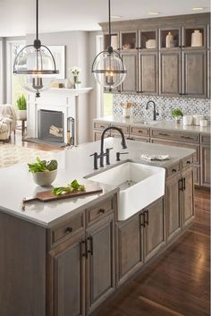 a large kitchen with wooden cabinets and white counter tops, along with an island in the middle