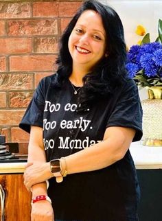 a woman standing in front of a brick wall