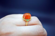 Gem: Mexican Fire Opal 18K gold: 5.2g (Au750 stamped) Opal weight: 6.257ct (stamped) Yellow Diamond: 0.176ct (Genuine) stamped Jadeite: 0.214ct(stamped) Ring size: US6 Treatments: every set stone are natural Color: as shown, can find the sharp sparks of color from different angle Clarity: transparent, precious fire opal Come with Ring box ready for gifting or keepping We look forward to the opportunity of serving you！ Yellow Gold Round Cabochons For Fine Jewelry, Yellow Gold Round Cabochons Fine Jewelry, Classic Yellow Gold Cabochons As A Gift, Classic Yellow Gold Cabochons For Gifts, Yellow Gold Gemstone Cabochons For Fine Jewelry, Luxury Cabochon Emerald Ring As Gift, Heirloom Style Cabochon Emerald Ring, Heirloom Emerald Cabochon Ring As Gift, Yellow Gold Gemstone Cabochons As Gifts