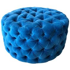 a blue round ottoman with buttons on the front and back legs, sitting on a white background