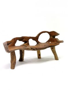 a wooden bench made out of branches with circles on the top and bottom, sitting in front of a white background