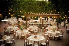 an outdoor wedding venue with tables and chairs