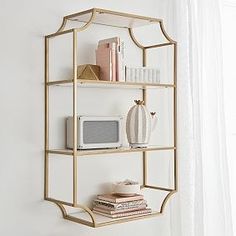 a shelf with books, microwave and other items on it