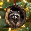 a raccoon hanging from a christmas tree ornament