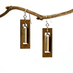 "These rectangular dangle earrings offer the boldness of a geometric design combined with the delicacy of a long, slender composition. The outer rectangle encompasses an inner panel for a multi-faceted design with movement and visual interest. Two tones of intricately cut wood - walnut and maple - give additional texture to the piece. Laser cut wood earrings can be dressed up or down, making them the perfect complement to any outfit! These earrings are strong but so lightweight and comfortable, Modern Brown Drop Earrings, Elegant Adjustable Geometric Earrings, Modern Dangle Linear Earrings, Modern Pierced Dangle Plug Earrings, Modern Pierced Dangle Linear Earrings, Adjustable Modern Linear Earrings, Modern Adjustable Earrings, Modern Long Drop Earrings As Gift, Modern Adjustable Earrings For Pierced Ears