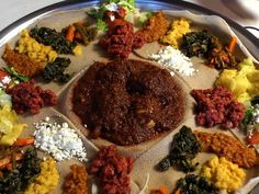 a platter filled with lots of food on top of a table