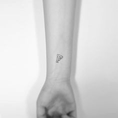 a person's arm with a small piece of pizza on the left side of their arm