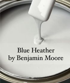 a white paint can with the words blue heather by benjamin moore on it and an image of a brush