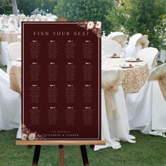 a seating chart for an outdoor wedding with white linens and flowers on the table