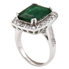 Stamped: 14K White Gold Total Ring Weight: 7.5 Grams Gemstone Weight: Total Natural Emerald Weight is 4.80 Carat (Measures: 13.95x10.20 mm) Color: Green Diamond Weight: Total Natural Diamond Weight is 1.20 Carat Quantity: 30 Color: F-G, Clarity: VS2-SI1 Face Measures: 19.30x16.25 mm Sku: [704023W] Classic Gia Certified Emerald Cut Gemstones, Formal Gia Certified Emerald Gemstones, Formal Emerald Gemstones With Prong Setting, Elegant Emerald Cut Platinum Gemstone, Gia Certified White Gold Gemstones For Anniversary, Elegant Emerald Gemstones With Center Stone, Formal Diamond Ring With Prong Setting For May Birthstone, Formal May Birthstone Diamond Ring With Prong Setting, Elegant Gemstones With Halo Setting For Anniversary