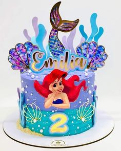 the little mermaid birthday cake is decorated with fondant and under water decorations, which spell it's 2