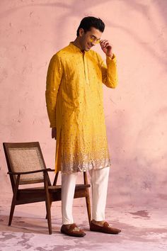 SHRESTHA By VASTRAMAY Men's Yellow Georgette Zari With Sequins Worked Kurta pant Set Elevate your traditional wardrobe with the exquisite SHRESTHA By VASTRAMAY Men's Yellow Georgette Zari With Sequins Worked Kurta Pant Set. Crafted with meticulous detail, this set combines classic elegance with contemporary style, perfect for festive occasions and special events. Features Elegant yellow georgette fabric Intricate zari and sequins work Comfortable fit with stylish design Ideal for festive and special occasions Specifications Brand: SHRESTHA By VASTRAMAY Color: Yellow Fabric: Georgette Work: Zari with sequins Set Content: Kurta and Pant Material & Care Material: Georgette Care: Dry clean only to maintain the intricate work and fabric quality Legal Disclaimer: The product is guaranteed to be Fitted Yellow Bottoms For Festive Season, Fitted Yellow Bottoms For Festive Occasions, Festival Straight Yellow Kurta, Yellow Chanderi Sherwani Straight Kurta, Yellow Mirror Work Kurta For Men, Yellow Unstitched Kurta, Luxury Yellow Jamawar Kurta, Kurta With Pants, Sleeveless Jacket