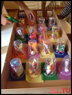 a box filled with lots of different types of cups and containers on top of a table