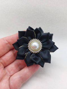 Black ribbon brooch with rhinestone pearl centre Measures 6 cm approx. Beautiful handmade elegant brooch Elegant Flower Pins For Parties, Elegant Flower Shaped Pins For Party, Elegant Handmade Flower Pins As Gift, Elegant Party Hair Accessories Brooch, Elegant Flower Shaped Party Pins, Elegant Flower Hair Accessories For Gift, Elegant Handmade Flower Pins For Gifts, Black Brooch Pins For Party, Elegant Handmade Flower Hair Accessories For Formal Occasions