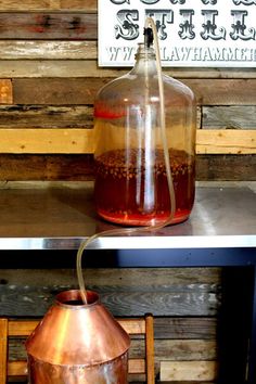 an old fashioned copper pot with liquid in it