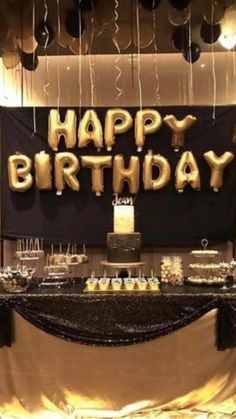 a birthday party with black and gold decorations