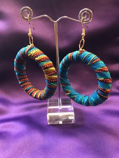 African Fabric Hoops made with wood, African Wax Print and gold plated or silver plated wires. Off cuts from our clothing collection is put to good use in these amazing African Print Hoops. Colourful African accessories add a simple flash of colour to your style. An all black outfit comes alive or your colourful African outfit gains even more with our wickedly vibrant earrings. All our jewellery qualifies for free domestic and international shipping when purchased alone.  Care-  - Fabric earring Handmade Fusion Round Earrings, Fusion Style Drop Earrings For Festivals, Handmade Round Fusion Earrings, Handmade Adjustable Traditional Hoop Earrings, Traditional Handmade Adjustable Hoop Earrings, Handmade Hoop Earrings For Celebration, Green Round Earrings For Festivals, Unique Multicolor Festive Earrings, Festive Fusion Style Handmade Hoop Earrings