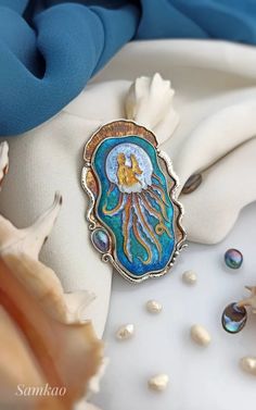 a brooch with an image of a jellyfish on it