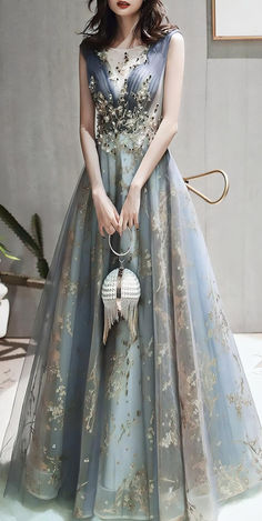 Discover this stunning sky blue evening gown with luxurious golden embroidery, perfect for weddings, galas, and formal events. The A-line silhouette and intricate floral details make it a must-have for any elegant occasion. Perfect for outfit ideas, style inspiration, and fashion lovers seeking unique, elegant dresses. Ethereal Evening Gown With Fitted Bodice, Elegant Fairy Dress Ball Gown For Wedding, Ethereal Ball Gown For Party, Elegant Ball Gown Fairy Dress For Wedding, Elegant Sleeveless Fairy Dress For Prom, Ethereal Gown With Fitted Bodice For Prom, Ethereal Evening Dress With Fitted Bodice For Party, Ethereal Maxi Dress For Party, Ethereal Maxi Length Party Dress