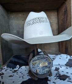 "Have a hat and buckle that you wear every day? Or maybe a special hat and buckle from that one special horse or one special rodeo? This stand is the perfect piece for you! Made from genuine horse shoes, this display is meant to sit on your dresser, on a shelf, or on your nighstand. Stands approximately 11\" tall, fits most hats and most buckles." Adjustable Rodeo Hat With Single Vent, Adjustable Hats With Single Vent For Rodeo, Adjustable Hat With Single Vent For Rodeo, White Southwestern Hat For Rodeo, Country Hat With Concho And Short Brim, White Southwestern Style Hat For Rodeo, Country Style Concho Hat For Rodeo, Country Style Hat With Concho And Short Brim, Southwestern Concho Hat For Rodeo