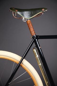 a close up of a bike with a saddle on it's handlebars