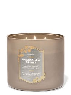 a candle that is inside of a metal container with the words marshmallow fireside on it