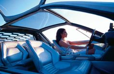 a woman sitting in the driver's seat of a car