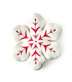 a white and red snowflake on a white background