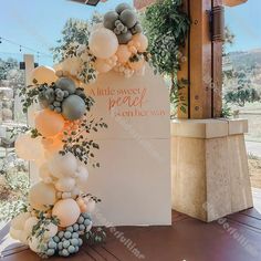 balloons and greenery decorate the entrance to a wedding reception at little sweet peace is on her way