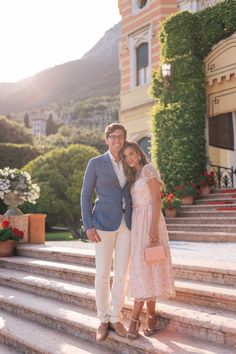 a man and woman standing in front of some steps