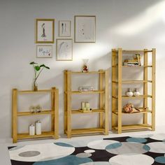 a living room with three wooden shelves and pictures on the wall above it, along with a black and white polka dot rug