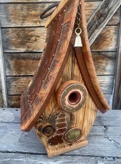 a bird house made out of wood and metal