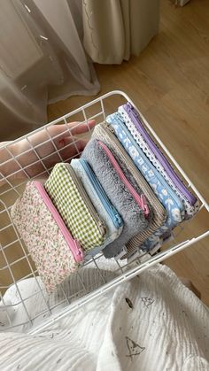 a white wire basket filled with lots of folded towels