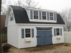 a white garage with blue doors and windows