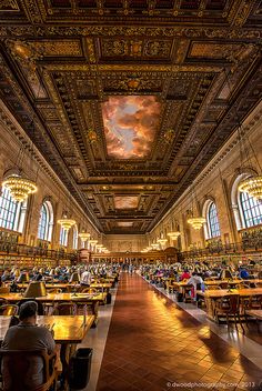 the interior of an old library with many tables and people sitting at their desks