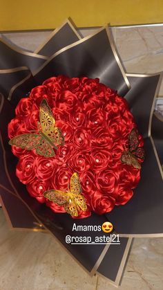 red roses in a black box with butterflies