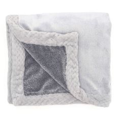 a gray and white blanket folded up on top of each other, with a square in the center