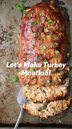 meatloaf on a baking sheet with a serving spoon