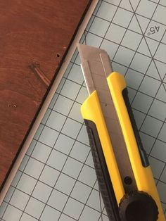 a pair of scissors sitting on top of a cutting board