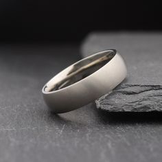 a wedding ring sitting on top of a rock