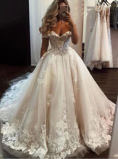 a woman is taking a selfie in her wedding dress while looking into the mirror